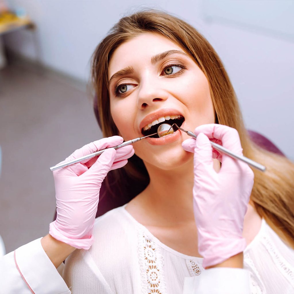 A digital X-ray of wisdom teeth being reviewed during a cost consultation at a San Diego oral surgery office.