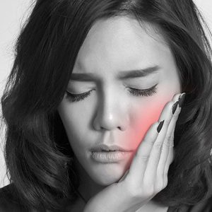 A leading San Diego TMJ specialist explaining jaw joint health to a patient during a consultation at Elevated Oral Surgery.